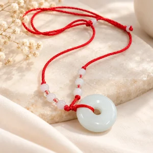 Collier disque de jade blanc sur cordon rouge